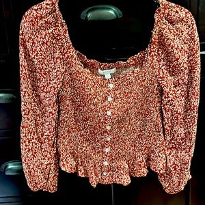 Cute smocked top in a rust and white print. Can be worn off-shoulder.